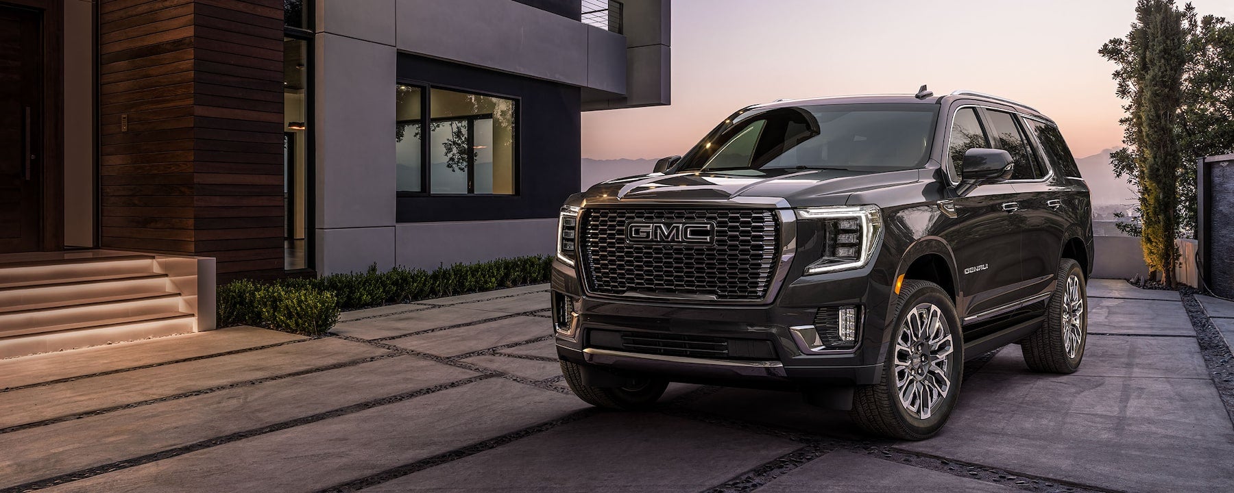 2023 yukon denali parked outside house