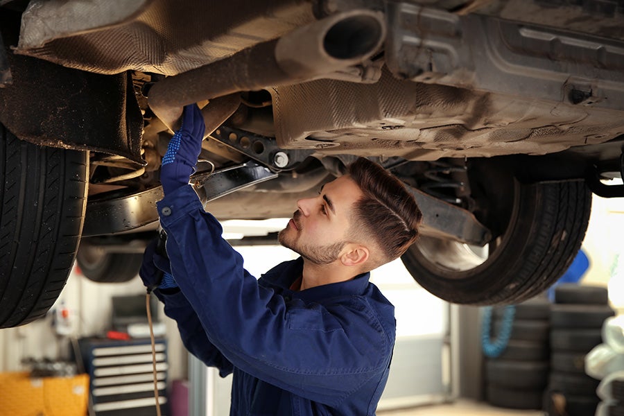 service techinician working under a car